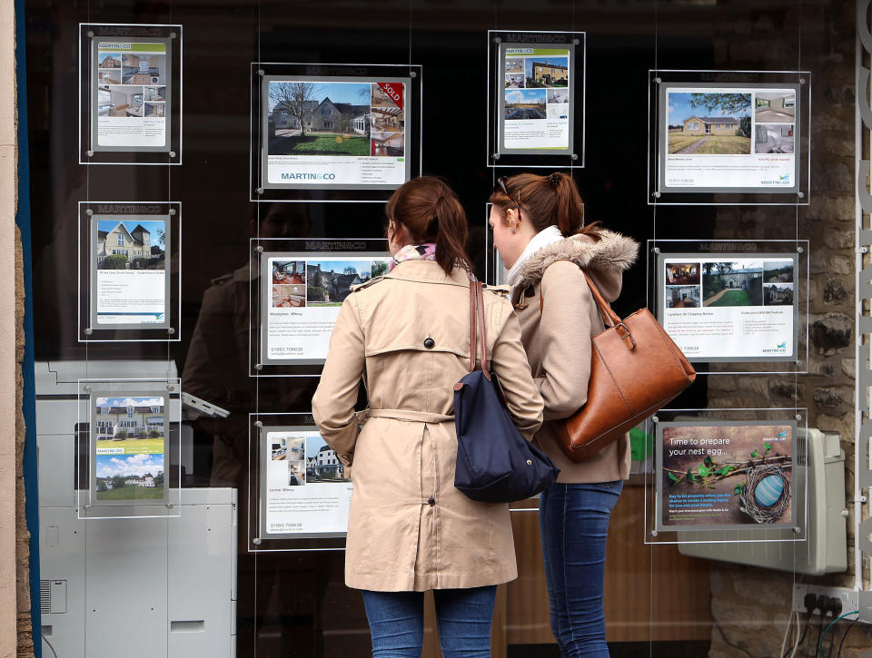 A general picture of two young people looking at an Estate Agents window in Whitney, OXfordshire
 