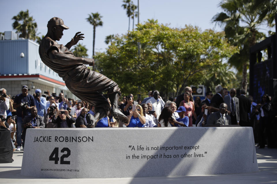 FILE - A bronze statue of Brooklyn Dodgers' Jackie Robinson is unveiled outside Dodger Stadium in Los Angeles before the Los Angeles Dodgers' baseball game against the Arizona Diamondbacks, Saturday, April 15, 2017, in Los Angeles. The 19-foot, 4,000-pound statue of Kobe Bryant in downtown Los Angeles is just the latest example of a sports team honoring a player with this kind of larger-than-life presence.(AP Photo/Jae C. Hong, File)