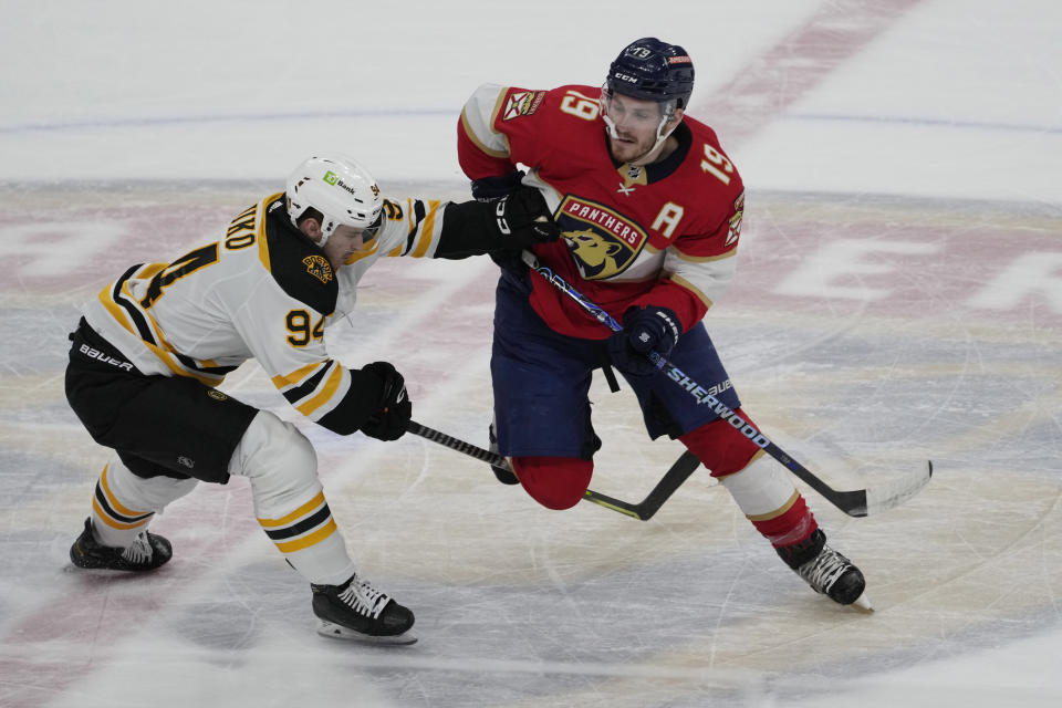 Boston Bruins center Jakub Lauko (94) defends Florida Panthers left wing Matthew Tkachuk (19) during the first period of Game 4 of an NHL hockey Stanley Cup first-round playoff series, Sunday, April 23, 2023, in Sunrise, Fla. (AP Photo/Marta Lavandier)