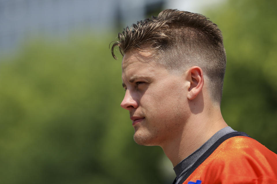 Cincinnati Bengals' Joe Burrow walks to the field before NFL football practice in Cincinnati, Wednesday, July 28, 2021. (AP Photo/Aaron Doster)