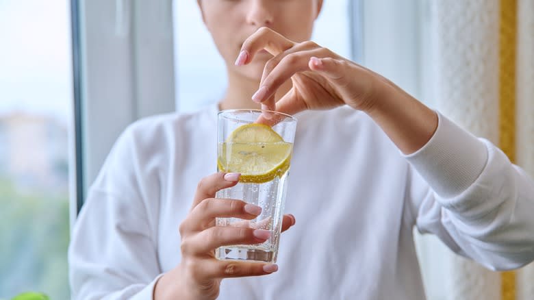 woman drinking lemon water