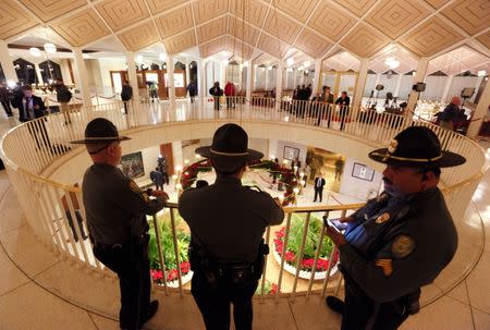 North Carolina State Highway troopers keep watch in the rotunda of the Legislative Building as lawmakers negotiate over repealing the controversial HB 2 law limiting bathroom access for transgender people in Raleigh, North Carolina, U.S. December 21, 2016. REUTERS/Jonathan Drake