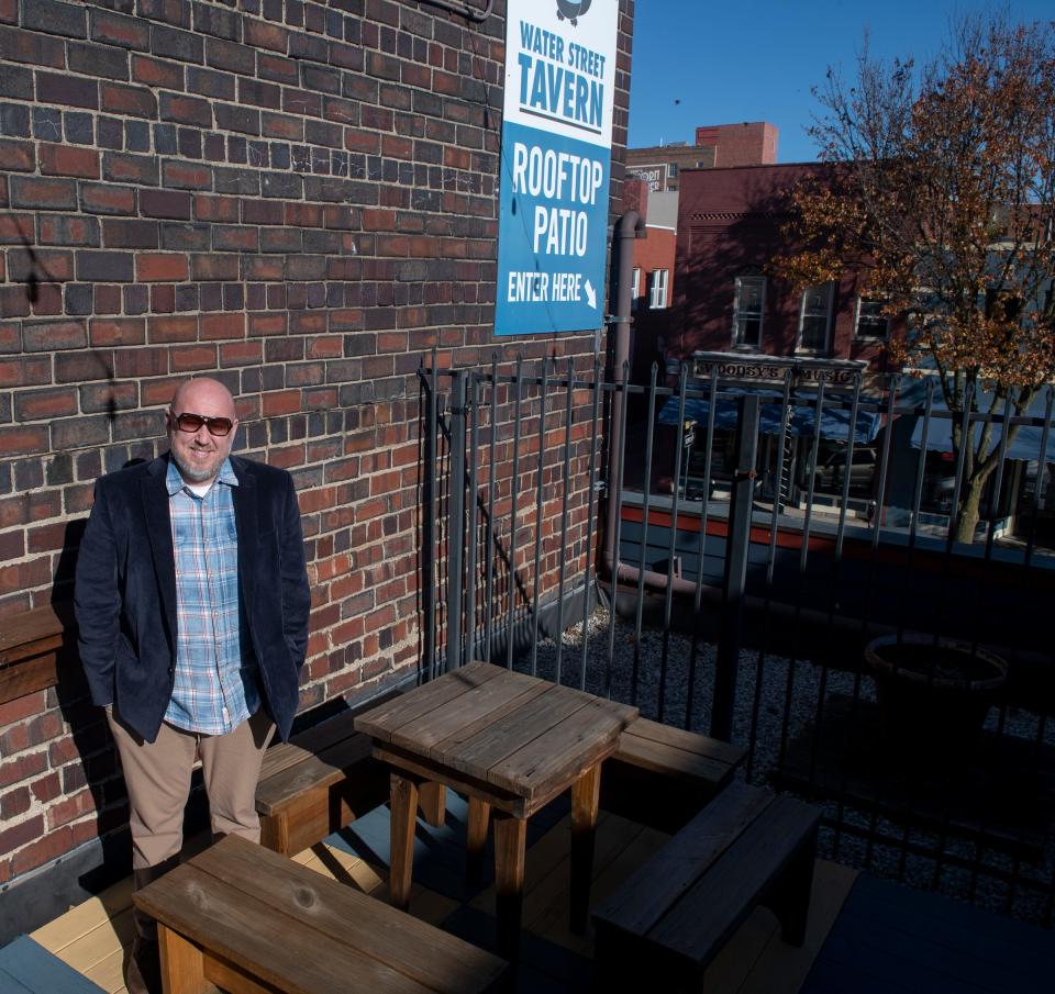 Mike Beder stands atop the Water Street Tavern on the rooftop patio. The business, which he started 21 years ago, was the first of several successful ventures in Kent.