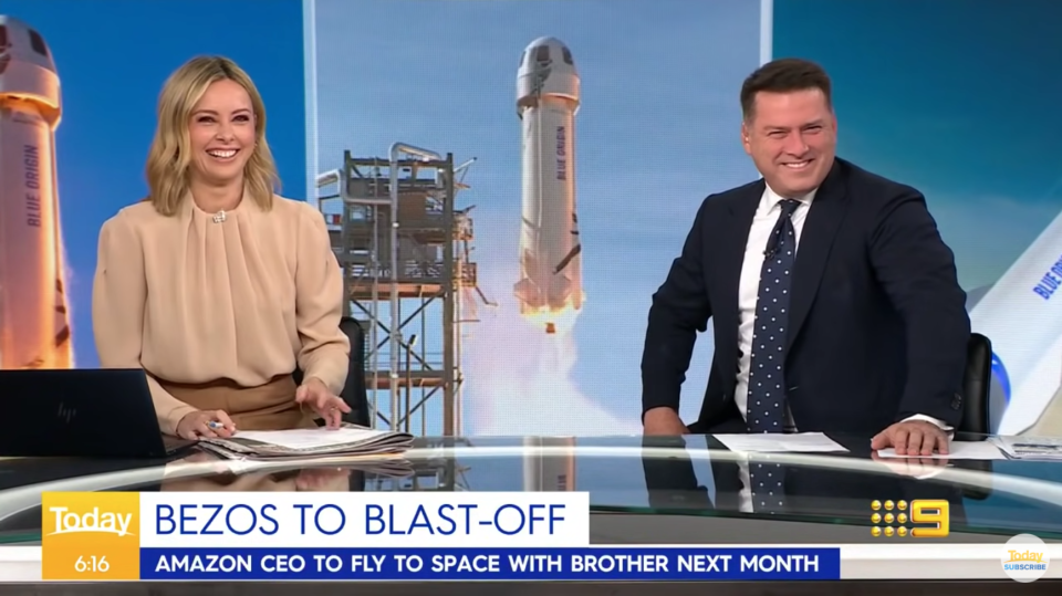 Allison Langdon and Karl Stefanovic laugh over the shape of Jeff Bezos' space rocket in the background.