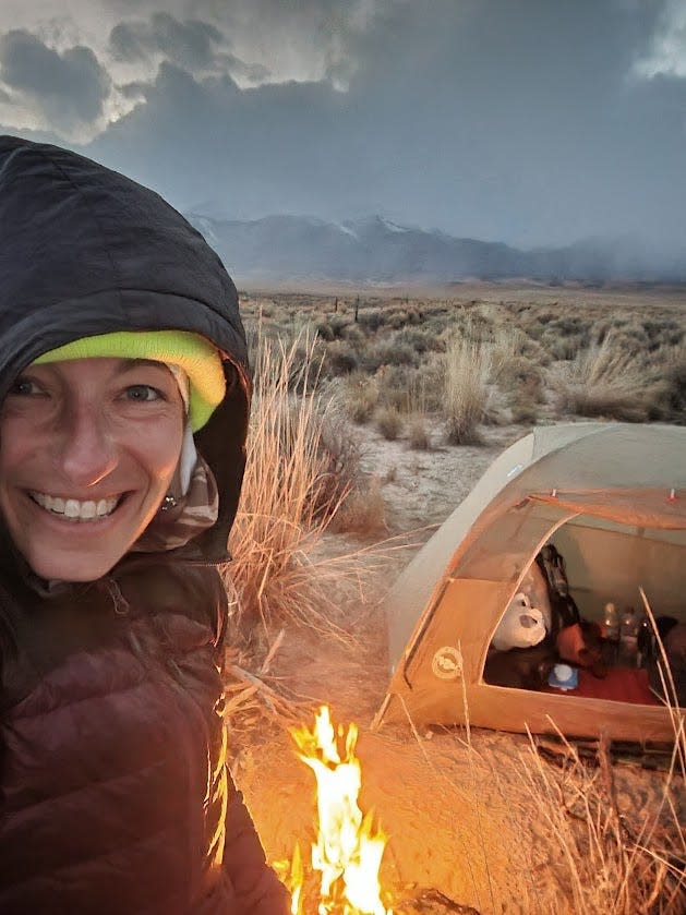 Briana DeSanctis poses for a selfie while camping in November near Alta Toquima Wilderness beside an old windmill.