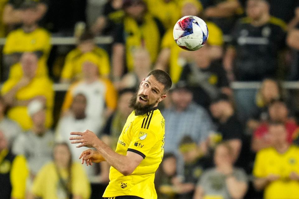 Apr 15, 2023; Columbus, Ohio, United States;  Columbus Crew defender Milos Degenek (5) heads the ball during the second half of the MLS soccer game between Columbus Crew and New England Revolution at Lower.com Field on Saturday evening. Mandatory Credit: Joseph Scheller-The Columbus Dispatch