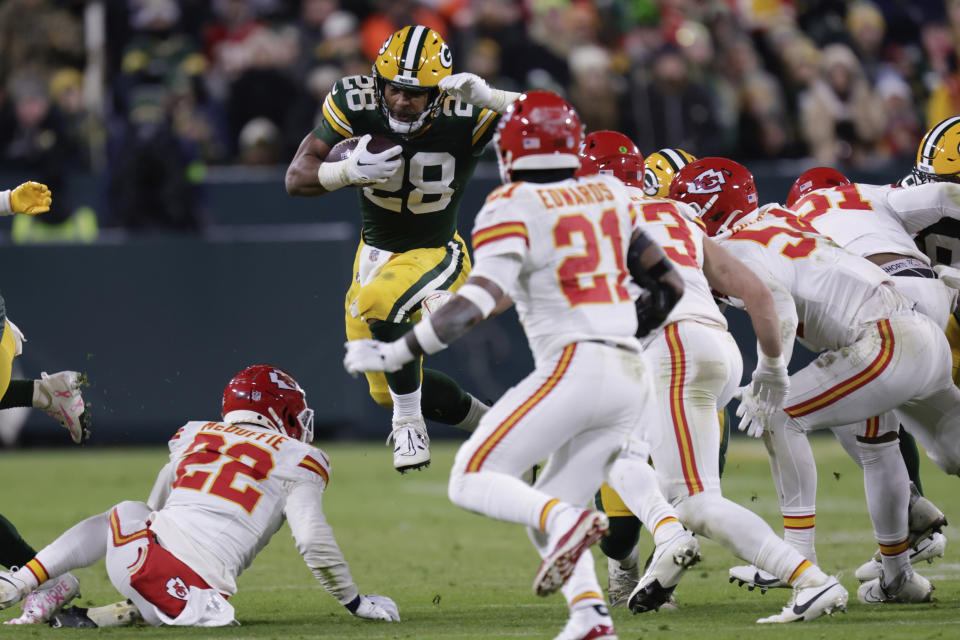 Green Bay Packers running back AJ Dillon (28) runs the ball against the Kansas City Chiefs during the second half of an NFL football game Sunday, Dec. 3, 2023 in Green Bay, Wis. (AP Photo/Matt Ludtke)