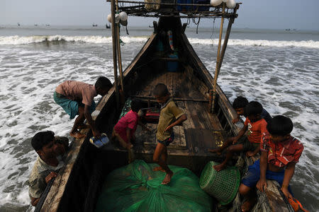 Rohingya refugees crew a fishing boat in the Bay of Bengal near Cox's Bazaar, Bangladesh, March 24, 2018. REUTERS/Clodagh Kilcoyne