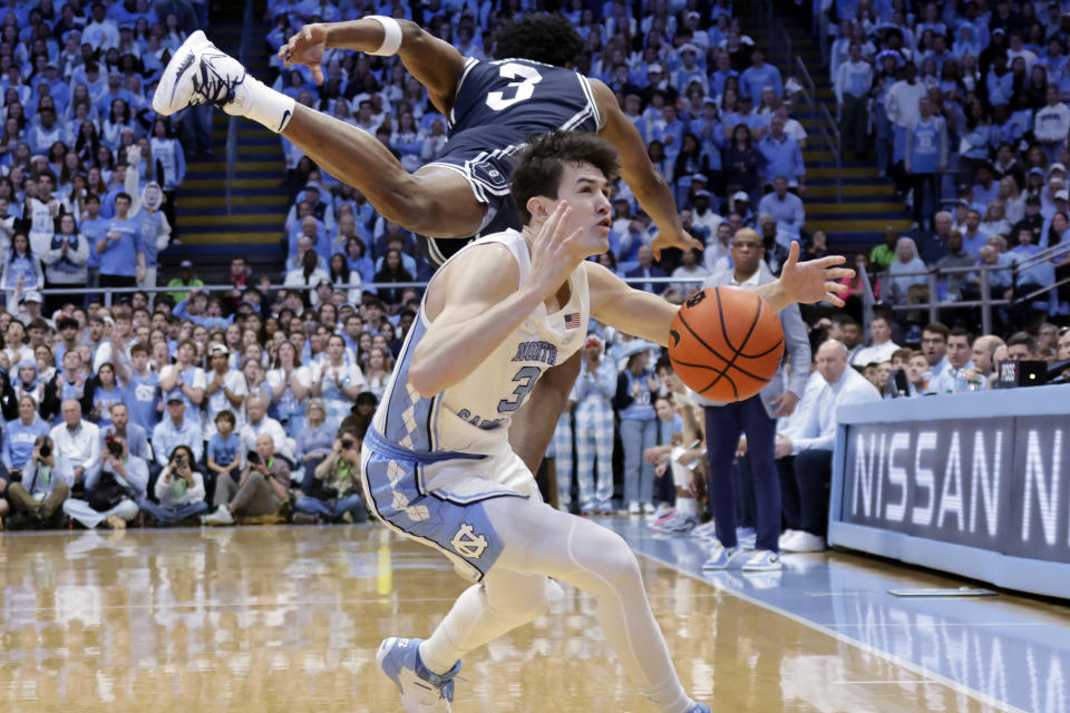 Duke guard Jeremy Roach, top, sails over North Carolina guard Cormac Ryan, bottom, during the first half of an NCAA college basketball game Saturday, Feb. 3, 2024, in Chapel Hill, N.C. (AP Photo/Chris Seward)