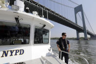 <p>Lt. John Smerina of the New York City Police Department Harbor Unit patrols on the first day of Fleet Week aboard the Dillon Stewart as she passes under the Verrazano-Narrows Bridge in New York, Wednesday, May 25, 2016. The annual Fleet Week is bringing a flotilla of activities, including a parade of ships sailing up the Hudson River and docking around the city. The events continue through Memorial Day. (AP Photo/Richard Drew) </p>