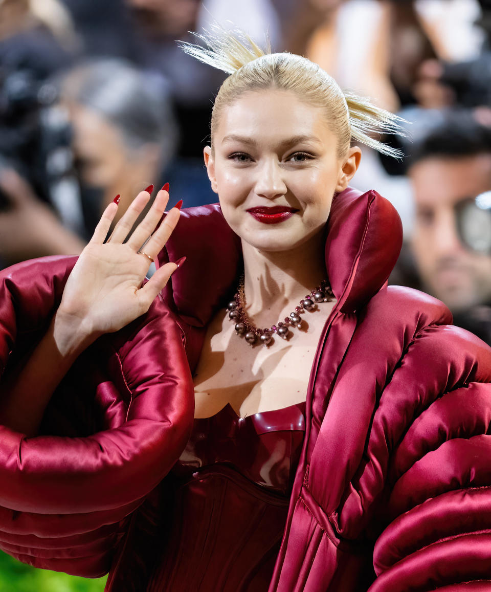 Gigi Hadid waves and smiles