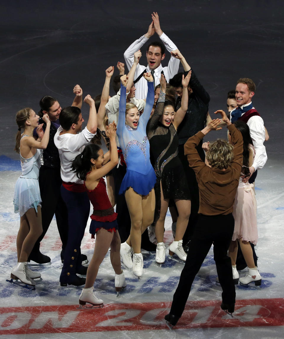 The U.S. Olympic figure skating team headed to Sochi do a group cheer on mid-ice at the end of their skating spectacular after the U.S. Figure Skating Championships in Boston, Sunday, Jan. 12, 2014. (AP Photo/Elise Amendola)