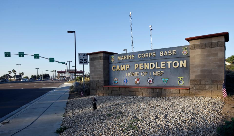 This Nov. 13, 2013 file photo shows the main gate of Camp Pendleton Marine Base at Camp Pendleton, Calif. A human smuggling investigation by the military led to the arrest of 16 Marines Thursday, July 25, 2019 while carrying out a battalion formation at California's Camp Pendleton, a base about an hour's drive from the U.S.-Mexico border.