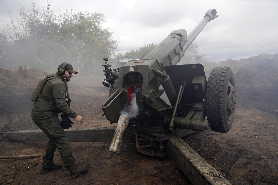 Ukrainian soldiers fire, on the front line in the Kharkiv region, Ukraine, Wednesday, Oct. 5, 2022. (AP Photo/Andrii Marienko)