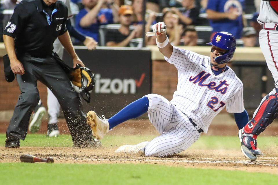 Aug 13, 2023; New York City, New York, USA; New York Mets third baseman Mark Vientos (27) slides safely at home in the fifth inning against the Atlanta Braves at Citi Field. Mandatory Credit: Wendell Cruz-USA TODAY Sports