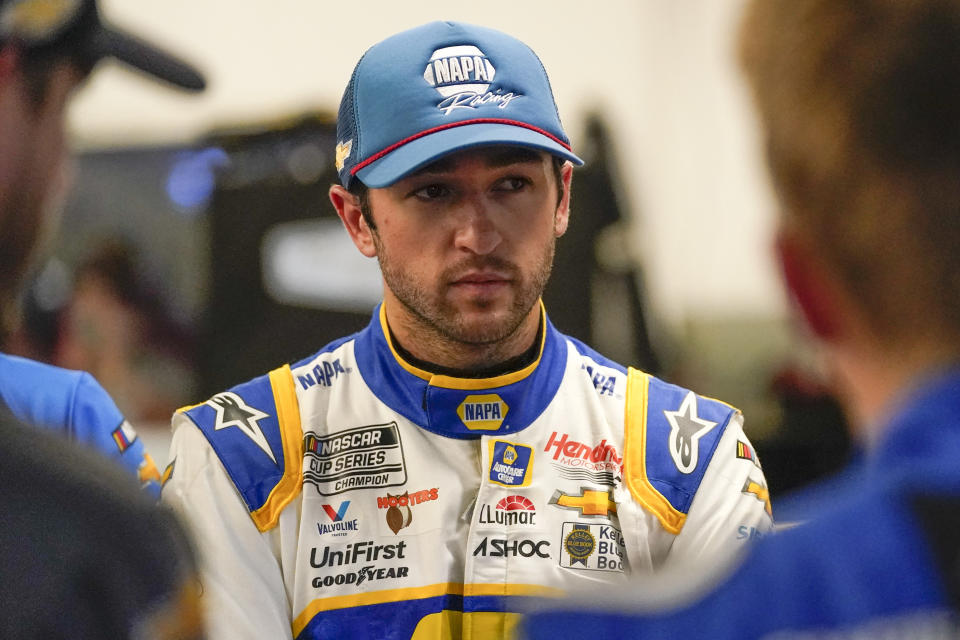 Chase Elliott talks with team members in the garage during NASCAR Daytona 500 auto race practice at Daytona International Speedway, Friday, Feb. 18, 2022, in Daytona Beach, Fla. (AP Photo/John Raoux)