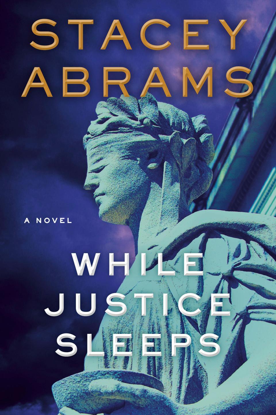 This image released by Doubleday shows “While Justice Sleeps,” a novel by Stacey Abrams.