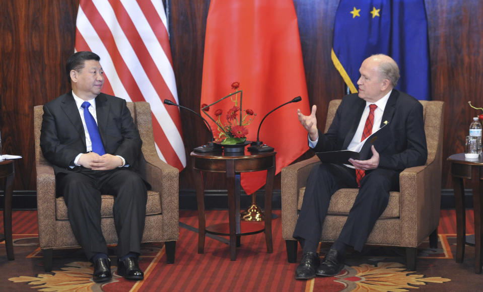 Chinese President Xi Jinping, left, listens to Alaska Governor Bill Walker at a meeting Friday April 7, 2017, in Anchorage, Alaska. Xi requested time with Gov. Walker Friday night as the Chinese delegation's plane made a refueling stop in Alaska's largest city following meetings with President Donald Trump in Florida. (AP Photo/Michael Dinneen)