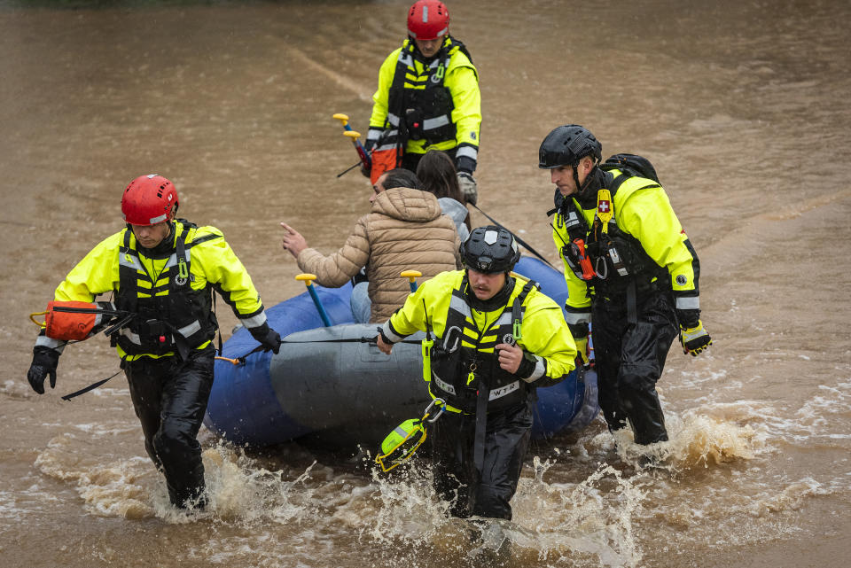 Firefighters with the Winston-Salem Fire Department evacuate residents at Creekwood Apartments as flood waters rise on Thursday, Nov. 12, 2020 in Winston-Salem, N.C. (Andrew Dye/The Winston-Salem Journal via AP)