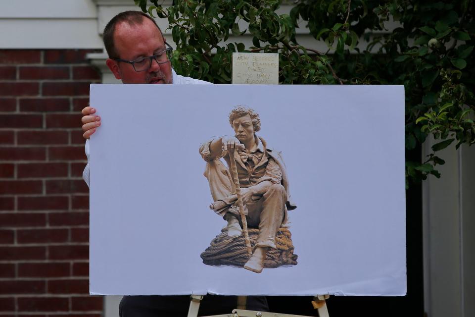 City of New Bedford Public Information Officer, Michael Lawrence, prepares a poster showing the future statue of Frederick Douglass which will be placed at Abolition Row Park, at the press conference announcing a MOTT Destination Development Captial Grant awarded to the Abolition Row Park on Seventh Street in New Bedford.