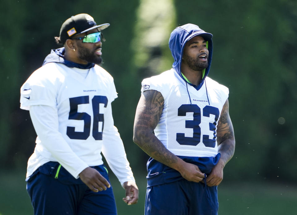 FILE - Seattle Seahawks linebacker Jordyn Brooks (56) and safety Jamal Adams (33) talk during NFL football practice, Tuesday, June 6, 2023, at the team's facilities in Renton, Wash.The Seahawks enter training camp with very few position competitions, but the important questions will surround health. (AP Photo/Lindsey Wasson, File)
