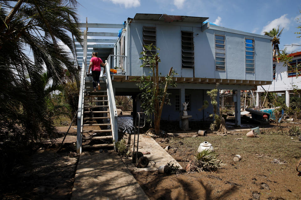 A woman looks at the damages to her house after the area was hit by Hurricane Maria in Toa Baja, Puerto Rico