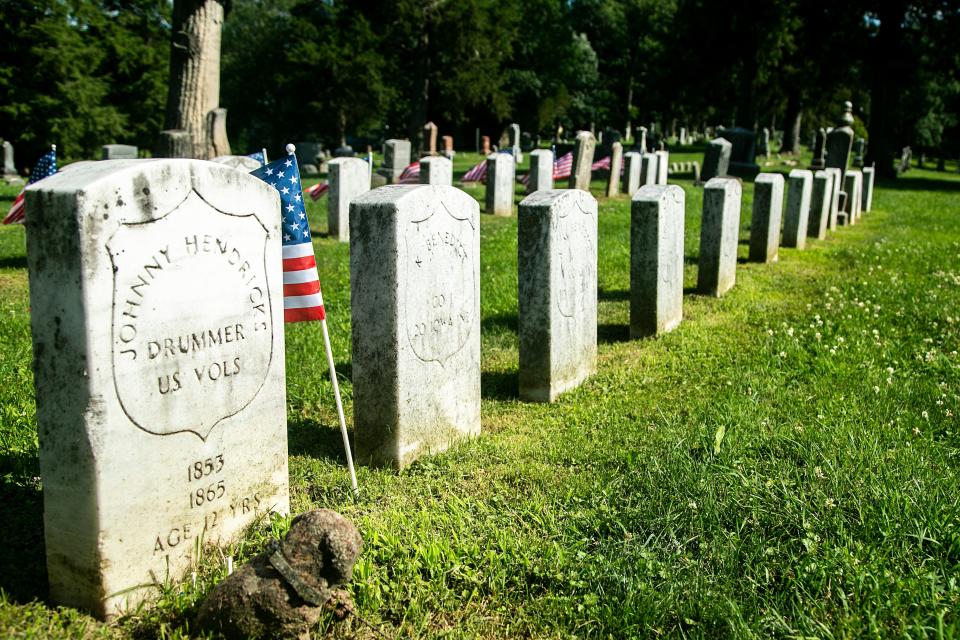 A grave for 12-year-old Johnny Hendricks, a drummer boy, is one of Civil War era headstones of veterans seen, Tuesday, July 12, 2022, at Oakland Cemetery in Iowa City, Iowa.