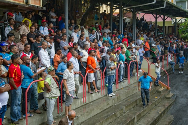 People watch horses as they are paraded at the Champ de Mars Race Course in Port Louis, Mauritius in October