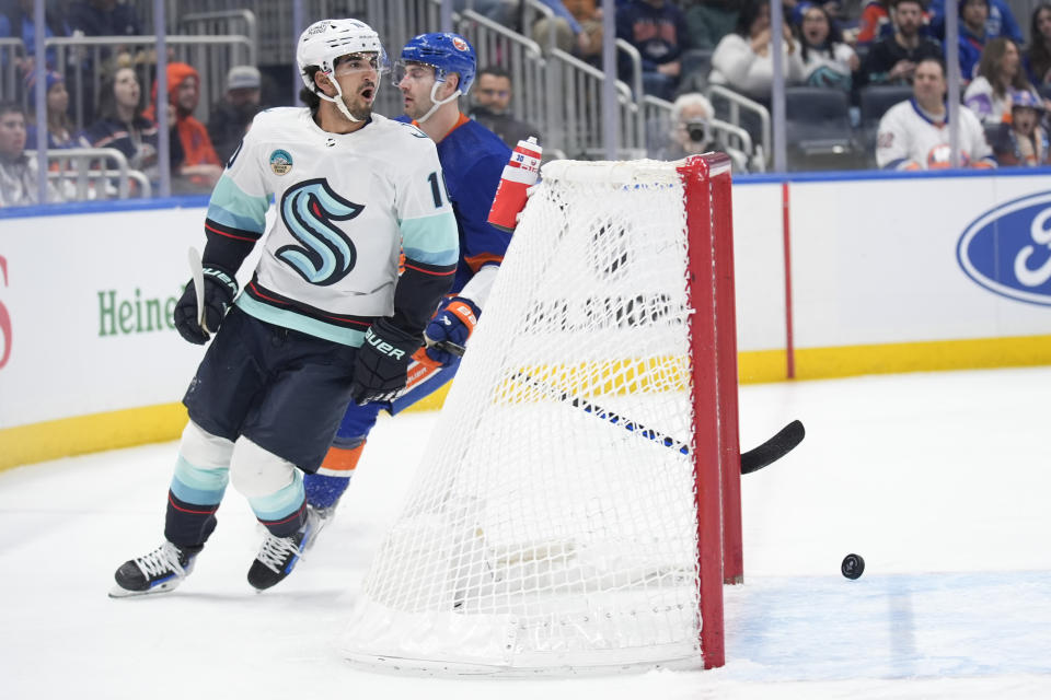 Seattle Kraken's Matty Beniers (10), left, reacts after scoring during the first period of an NHL hockey game against the New York Islanders, Tuesday, Feb. 13, 2024, in Elmont, N.Y. (AP Photo/Seth Wenig)