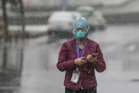 A goverment worker wearing a face mask waits for patients to arrive at a tumor hospital newly designated to treat COVID-19 patients in Wuhan in central China's Hubei Province, Saturday, Feb. 15, 2020. The virus is thought to have infected more than 67,000 people globally and has killed at least 1,526 people, the vast majority in China, as the Chinese government announced new anti-disease measures while businesses reopen following sweeping controls that have idled much of the economy. (Chinatopix via AP)