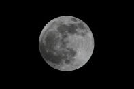 The moon is seen during a lunar eclipse over Mexico City,Tuesday April 15, 2014. Tuesday's eclipse is the first of four total lunar eclipses that will take place between 2014 to 2015. (AP Photo Marco/Ugarte)