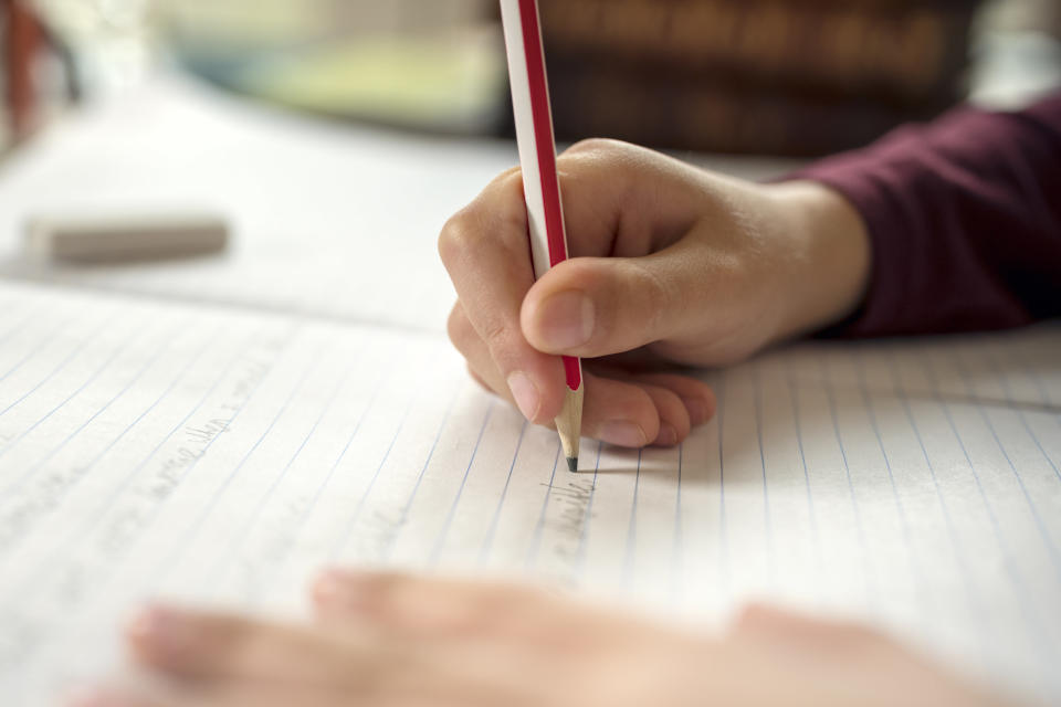 boy writing in a notebook