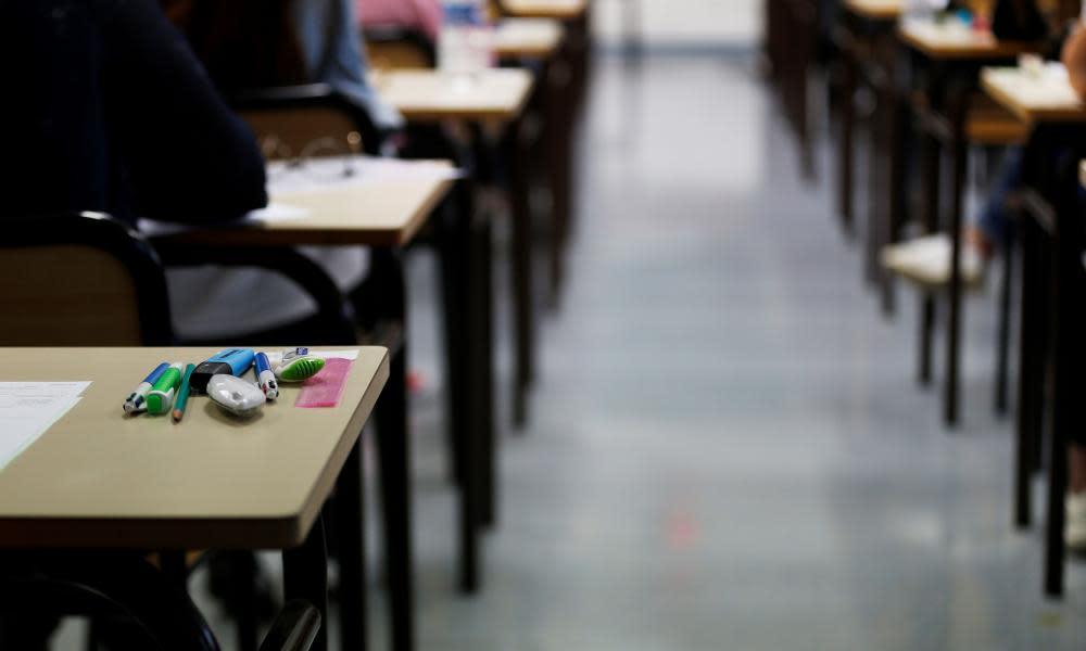 School students wait to start an exam