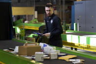 U.S. Customs and Border Protection technician Czar Zeman examines overseas parcels after they were scanned at the agency's overseas mail inspection facility at Chicago's O'Hare International Airport Feb. 23, 2024, in Chicago. The explosive growth of cross-border e-commerce involving major China-backed players such as Shein and Temu has caught the attention of the U.S. lawmakers amid a bitter U.S.-China trade war and cast a spotlight on a tax rule that critics say has allowed hundreds of millions of China-originated packages to enter the U.S. market each year without duty and without reliable information for lawfulness. (AP Photo/Charles Rex Arbogast)