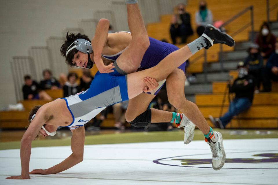 Fort Collins' Cam Soto wrestles Poudre High School's Flint Neagle in the 145-pound weight class during a wrestling dual Thursday at Fort Collins High School.