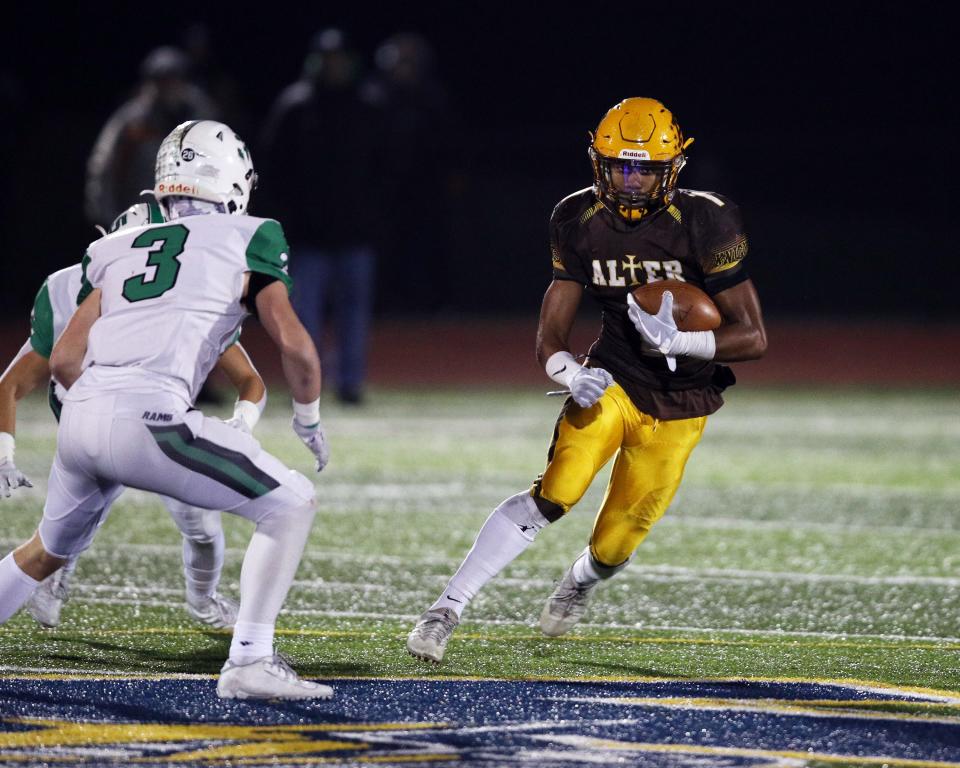 Kettering Alter's C.J. Hicks rushes against Hamilton Badin during a 2019 playoff game.