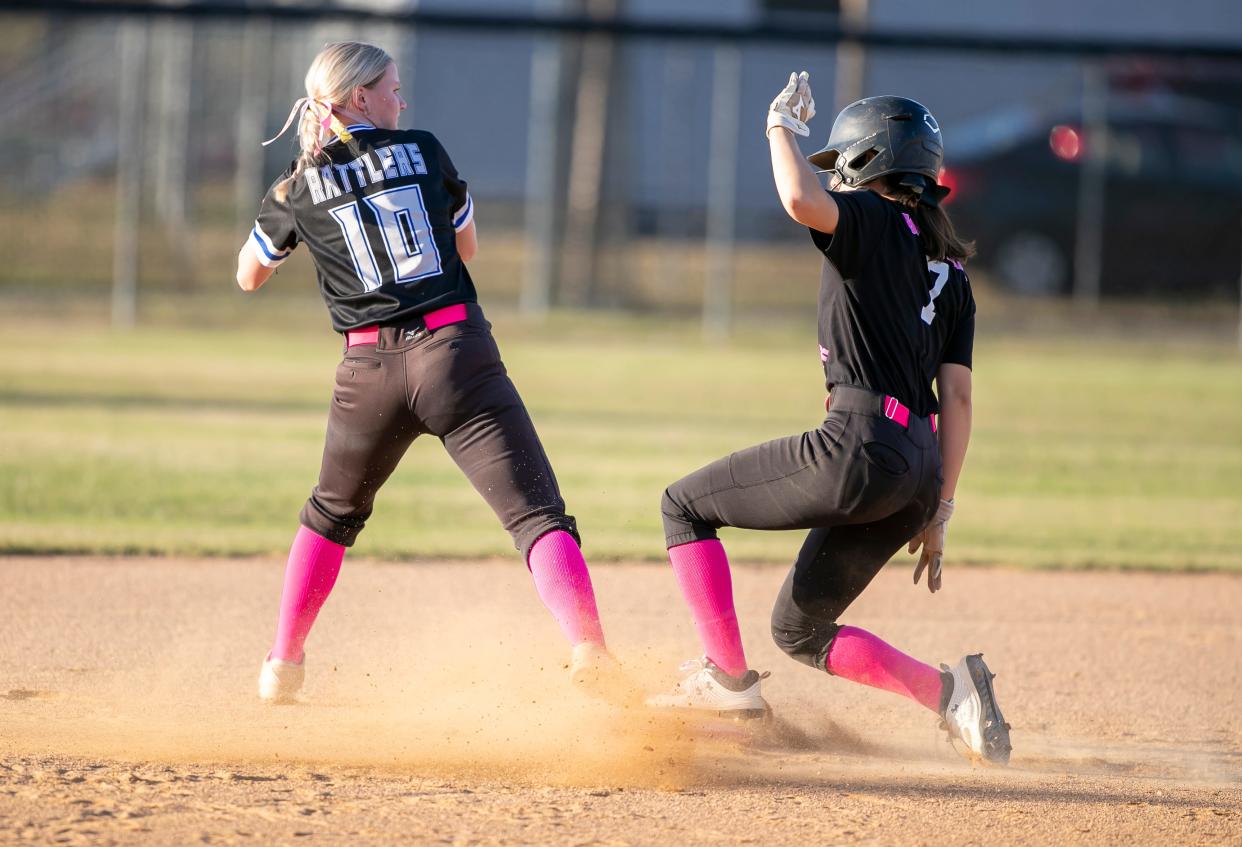 Belleview Emily Pearce (10) looks for the tag on West Port outfielder Alejandra Matos (7) gets to second base as Belleivew takes on West Port at West Port High School in Ocala, FL on Tuesday, April 18, 2023. [Alan Youngblood/Ocala Star-Banner]