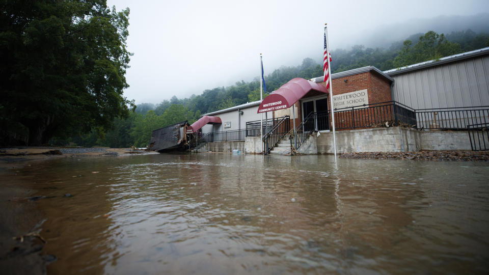 Water reaches up to the steps at the entry to Whitewood High School. 