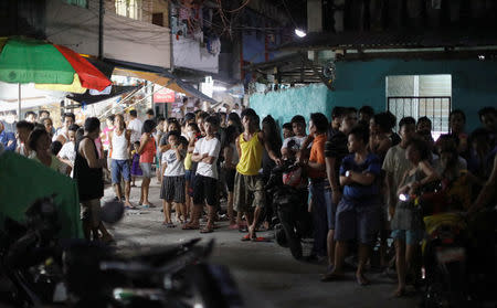 Residents gather along an alley after a police anti-drug operation in Caloocan city, Metro Manila, Philippines August 17, 2017. REUTERS/Erik De Castro