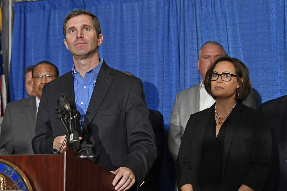 Kentucky Governor-Elect Andy Beshear, left, and Lt. Governor-Elect Jacqueline Coleman speak with reporters following the announcement of their transition team at the Capitol Rotunda in Frankfort, Ky., Friday, Nov. 15, 2019. (AP Photo/Timothy D. Easley)