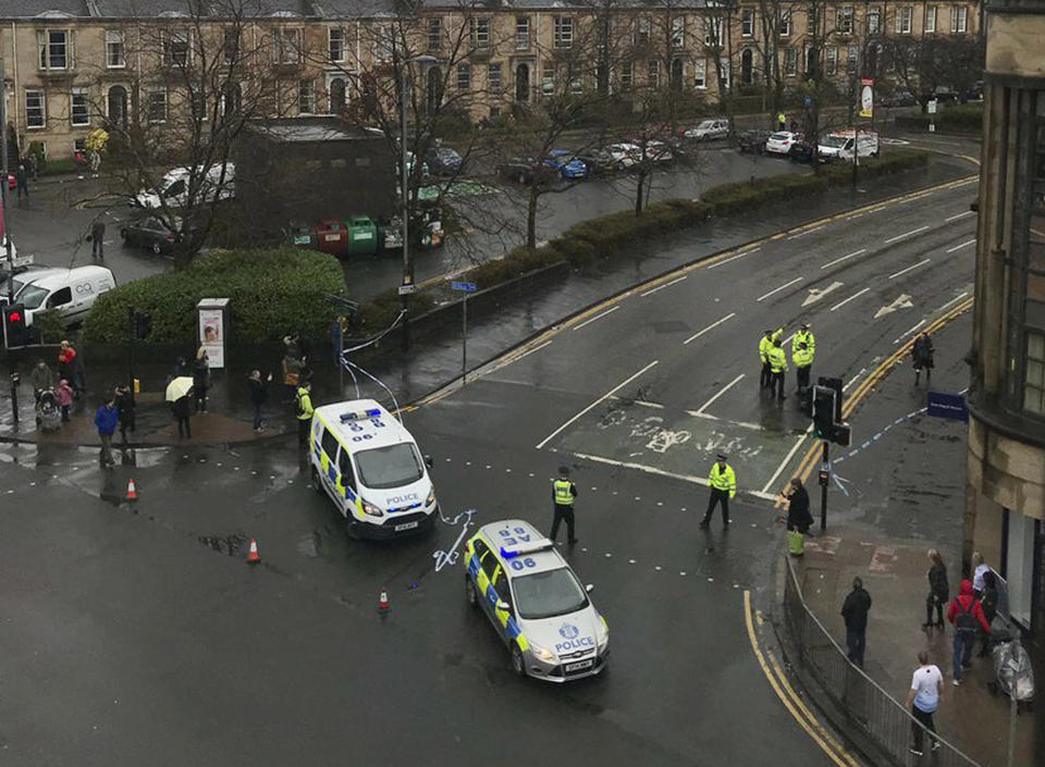 The scene as police secure the area outside the University of Glasgow, Scotland, after a suspicious package was found the university, Wednesday March 6, 2019. Police Scotland says officers are examining items found Wednesday morning at the University of Glasgow and the Royal Bank of Scotland headquarters in Edinburgh. (AP Photo/Lilli Schlossbach)