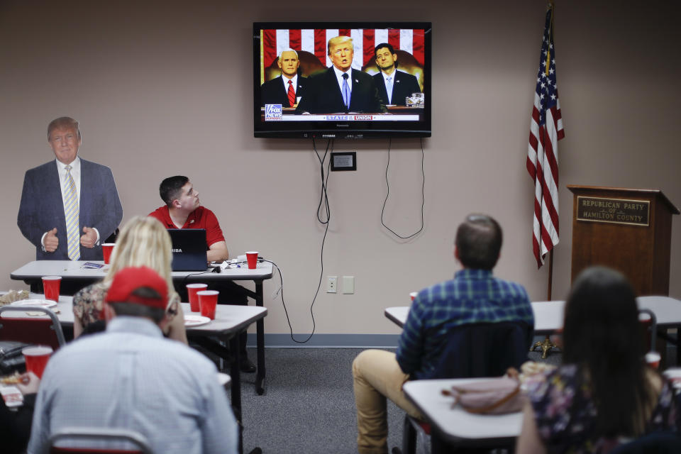 Supporters watch President Trump speak at a State of the Union watch party hosted by the Hamilton County Republican Party in Cincinnati on Tuesday. (AP Photo/John Minchillo)