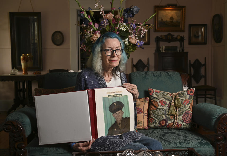 Portrait of Judy Wade, niece of Luther Story, with memory scrapbook of Luther Story, that her mother put together, Thursday, May 18, 2023, in Americus, Georgia. Army Pfc. Luther Herschel Story was awarded the Medal of Honor after he went missing in battle during the Korean War is being buried on Memorial Day near his hometown in Georgia. Wounded Story was last seen on Sept. 1, 1950, when he stayed behind to cover his infantry unit's retreat. (Hyosub Shin/Atlanta Journal-Constitution via AP)