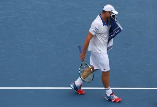 Andy Roddick wipes sweat from his face against Jeremy Chardy of France on August 14, 2012 in Mason, Ohio. Roddick lost to Chardy 7-6 (7/4), 6-3