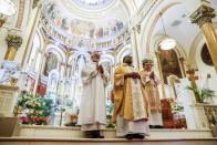 Father Ako Walker leads Easter Mass at Sacred Heart of Jesus and Saint Patrick, Sunday, March 31, 2024, in Baltimore, Md. (AP Photo/Julia Nikhinson)