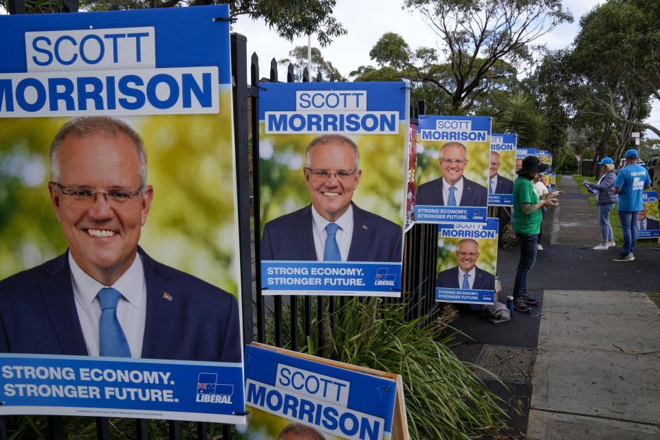 Volunteers stand outside a polling station as they wait for Australian Prime Minister to vote in Sydney, Australia, Saturday, May 21, 2022. Australians go to the polls Saturday following a six-week election campaign that has focused on pandemic-fueled inflation, climate change and fears of a Chinese military outpost being established less than 1,200 miles off Australia's shore.(AP Photo/Mark Baker)