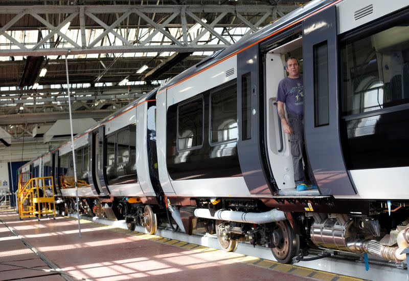 FILE PHOTO: A worker stands in the doorway of a train at the Bombardier plant in Derby