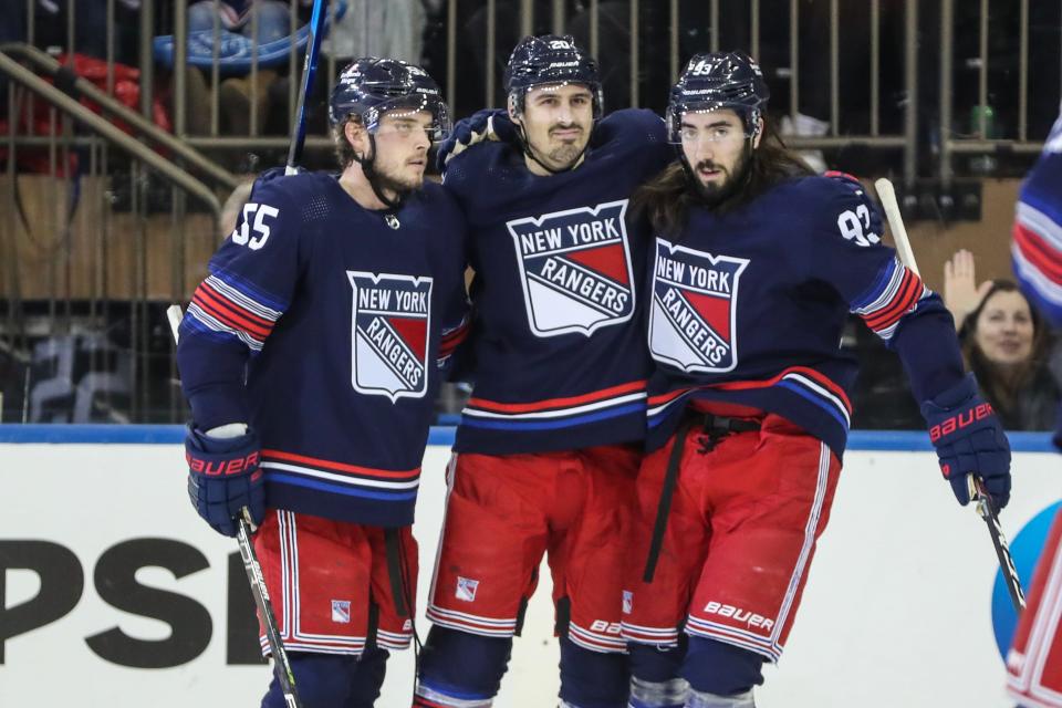 Dec 15, 2023; New York, New York, USA; New York Rangers left wing Chris Kreider (20) is greeted by defenseman Ryan Lindgren (55) and center Mika Zibanejad (93) after scoring a goal in the first period against the Anaheim Ducks at Madison Square Garden.