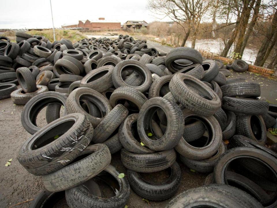 Illegal dumping of tyres along the banks of the Clyde in Glasgow (Alamy)