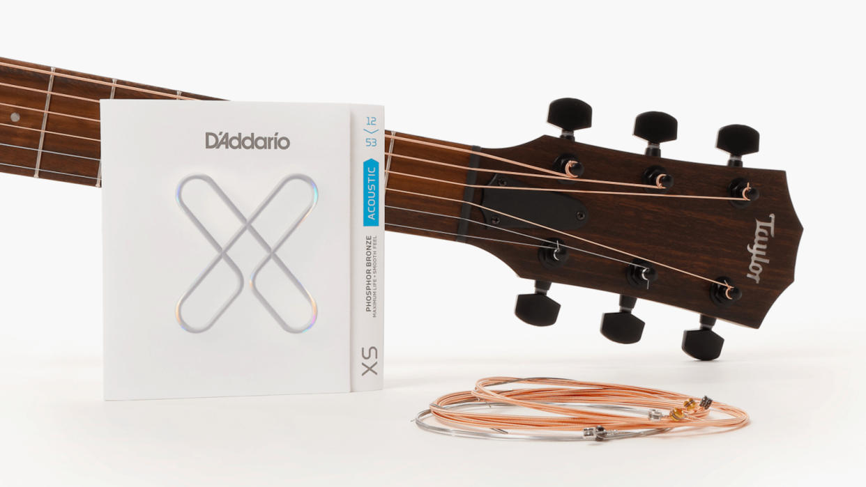  D'Addario XS packet and Taylor acoustic guitar headstock 